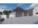 Spacious three-car garage with elegant stone exterior and paved driveway, offering ample parking at 25015 S 182Nd Pl, Gilbert, AZ 85298