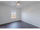 Bedroom with a ceiling fan and modern dark wood-look flooring with natural light at 30944 N Bramwell Ave, San Tan Valley, AZ 85143