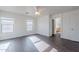 Bright bedroom with dark wood floors, ample natural light, and access to the ensuite bathroom at 30944 N Bramwell Ave, San Tan Valley, AZ 85143