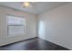 Simple yet spacious bedroom with light-colored walls, wood floors, and window at 30944 N Bramwell Ave, San Tan Valley, AZ 85143