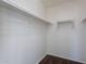 Walk-in closet features wood floors and multiple shelving options to help maximize space at 30944 N Bramwell Ave, San Tan Valley, AZ 85143