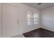 Bright entryway featuring modern wood-look flooring, white walls, and a front door at 30944 N Bramwell Ave, San Tan Valley, AZ 85143