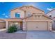 Inviting two-story home featuring a large two-car garage and a well-maintained front yard at 30944 N Bramwell Ave, San Tan Valley, AZ 85143