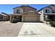 Traditional two-story home featuring a two-car garage, landscaped yard, and a neutral color palette at 30944 N Bramwell Ave, San Tan Valley, AZ 85143