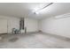 Spacious two-car garage with water heater, painted floor, and door to the house at 30944 N Bramwell Ave, San Tan Valley, AZ 85143
