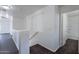 Bright hallway with modern dark wood-look flooring and white walls leading to a bathroom at 30944 N Bramwell Ave, San Tan Valley, AZ 85143