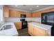 Bright kitchen with wood cabinets, a center island and modern appliances at 30944 N Bramwell Ave, San Tan Valley, AZ 85143