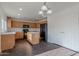 The kitchen features a central island, light wood cabinetry, and modern appliances at 30944 N Bramwell Ave, San Tan Valley, AZ 85143