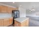 The kitchen features a central island, light wood cabinetry, and modern appliances at 30944 N Bramwell Ave, San Tan Valley, AZ 85143