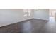 Bright living room with wood floors and window allowing ample natural light at 30944 N Bramwell Ave, San Tan Valley, AZ 85143