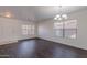 Welcoming living room showcasing dark floors and natural lighting at 30944 N Bramwell Ave, San Tan Valley, AZ 85143