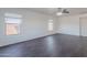 Living room featuring modern dark wood-look flooring and two windows at 30944 N Bramwell Ave, San Tan Valley, AZ 85143
