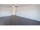Living room featuring modern dark wood-look flooring and a ceiling fan at 30944 N Bramwell Ave, San Tan Valley, AZ 85143