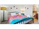 Bright bedroom with colorful bedspread, side table, and decorative hearts on the wall at 3314 N 68Th St # 129, Scottsdale, AZ 85251