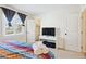 Bright bedroom featuring colorful bedding, TV on stand, and open closet at 3314 N 68Th St # 129, Scottsdale, AZ 85251
