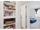 Hallway shelving with decorative items adjacent to bedroom at 3314 N 68Th St # 129, Scottsdale, AZ 85251