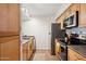 Kitchen featuring stainless steel refrigerator, tile flooring, and wood cabinets at 3314 N 68Th St # 129, Scottsdale, AZ 85251