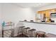 Kitchen bar with seating, stainless steel refrigerator and adjacent wine rack at 3314 N 68Th St # 129, Scottsdale, AZ 85251