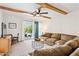 Inviting living room with exposed beam ceiling, ceiling fan and sliding glass doors to the outside at 3314 N 68Th St # 129, Scottsdale, AZ 85251