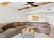 Comfortable living room with exposed beam ceiling, ceiling fan, and view into kitchen at 3314 N 68Th St # 129, Scottsdale, AZ 85251
