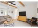 Living room with ceiling fan, exposed beam ceiling, comfortable chair and side table at 3314 N 68Th St # 129, Scottsdale, AZ 85251