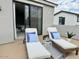 Outdoor balcony features two lounge chairs, a side table, and a small table with a toy truck at 3669 E Boot Track Trl, Gilbert, AZ 85296