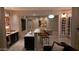 Open bar and dining area with a wine rack, bar seating, unique pendant lights, and decorative artwork at 3669 E Boot Track Trl, Gilbert, AZ 85296