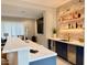 A modern bar area boasts a marble counter, stylish lighting, and well-stocked display shelves at 3669 E Boot Track Trl, Gilbert, AZ 85296