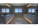 Expansive bathroom with double vanities under large mirrors and under cabinet lighting that illuminate a patterned floor at 3669 E Boot Track Trl, Gilbert, AZ 85296