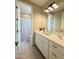 Well-lit bathroom featuring a large vanity with a mirror and gold accents at 3669 E Boot Track Trl, Gilbert, AZ 85296