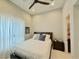 Cozy bedroom with a comfortable bed, ceiling fan, and natural light from the window at 3669 E Boot Track Trl, Gilbert, AZ 85296