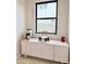 A cute coffee bar area with white cabinets and a large window at 3669 E Boot Track Trl, Gilbert, AZ 85296