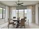 Cozy dining room with round table, neutral chairs, and sheer white curtains at 3669 E Boot Track Trl, Gilbert, AZ 85296