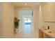 Bright entryway with light wood console table, plant, neutral paint, and view to the living room at 3669 E Boot Track Trl, Gilbert, AZ 85296