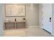 Light and airy entryway featuring tile flooring, a modern console table and decor at 3669 E Boot Track Trl, Gilbert, AZ 85296