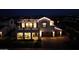 Striking two-story home illuminated at night, featuring a spacious balcony and a two-car garage at 3669 E Boot Track Trl, Gilbert, AZ 85296