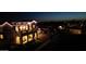 Beautifully lit two-story home at dusk, featuring a cozy balcony and manicured front lawn at 3669 E Boot Track Trl, Gilbert, AZ 85296