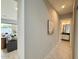 Hallway with light wood floors leads to a view of the Gathering room and bathroom at 3669 E Boot Track Trl, Gilbert, AZ 85296