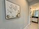 Hallway leads to the bathroom, decorated with a decorative painting at 3669 E Boot Track Trl, Gilbert, AZ 85296