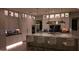 Elegant kitchen with a marble island, stainless steel appliances, custom lighting, and bar seating for entertaining at 3669 E Boot Track Trl, Gilbert, AZ 85296