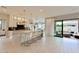 Bright kitchen with a large island and marble countertops open to a patio at 3669 E Boot Track Trl, Gilbert, AZ 85296