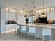 Gourmet kitchen featuring white cabinets, marble countertops, and pendant lights above island at 3669 E Boot Track Trl, Gilbert, AZ 85296