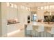 Bright kitchen with an island, pendant lighting, modern appliances, and stylish white cabinetry at 3669 E Boot Track Trl, Gilbert, AZ 85296