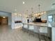 Spacious kitchen with a large island, modern pendant lighting, and lots of cabinet space at 3669 E Boot Track Trl, Gilbert, AZ 85296