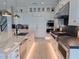 Modern kitchen with marble countertops, stainless steel appliances, and built-in lighting at 3669 E Boot Track Trl, Gilbert, AZ 85296