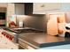 Wolf range with oven, and gray stone countertops for meal prep in kitchen at 3669 E Boot Track Trl, Gilbert, AZ 85296