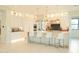 Open-concept kitchen with large center island, white cabinetry and stainless appliances at 3669 E Boot Track Trl, Gilbert, AZ 85296
