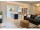 Open-concept living area with comfortable leather seating, a beverage bar and stylish decor at 3669 E Boot Track Trl, Gilbert, AZ 85296