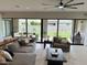 Bright living room with sliding glass doors, neutral color palette, and modern furnishings at 3669 E Boot Track Trl, Gilbert, AZ 85296