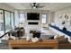 Elegant living room featuring a fireplace, large TV, and built-in bench seating at 3669 E Boot Track Trl, Gilbert, AZ 85296